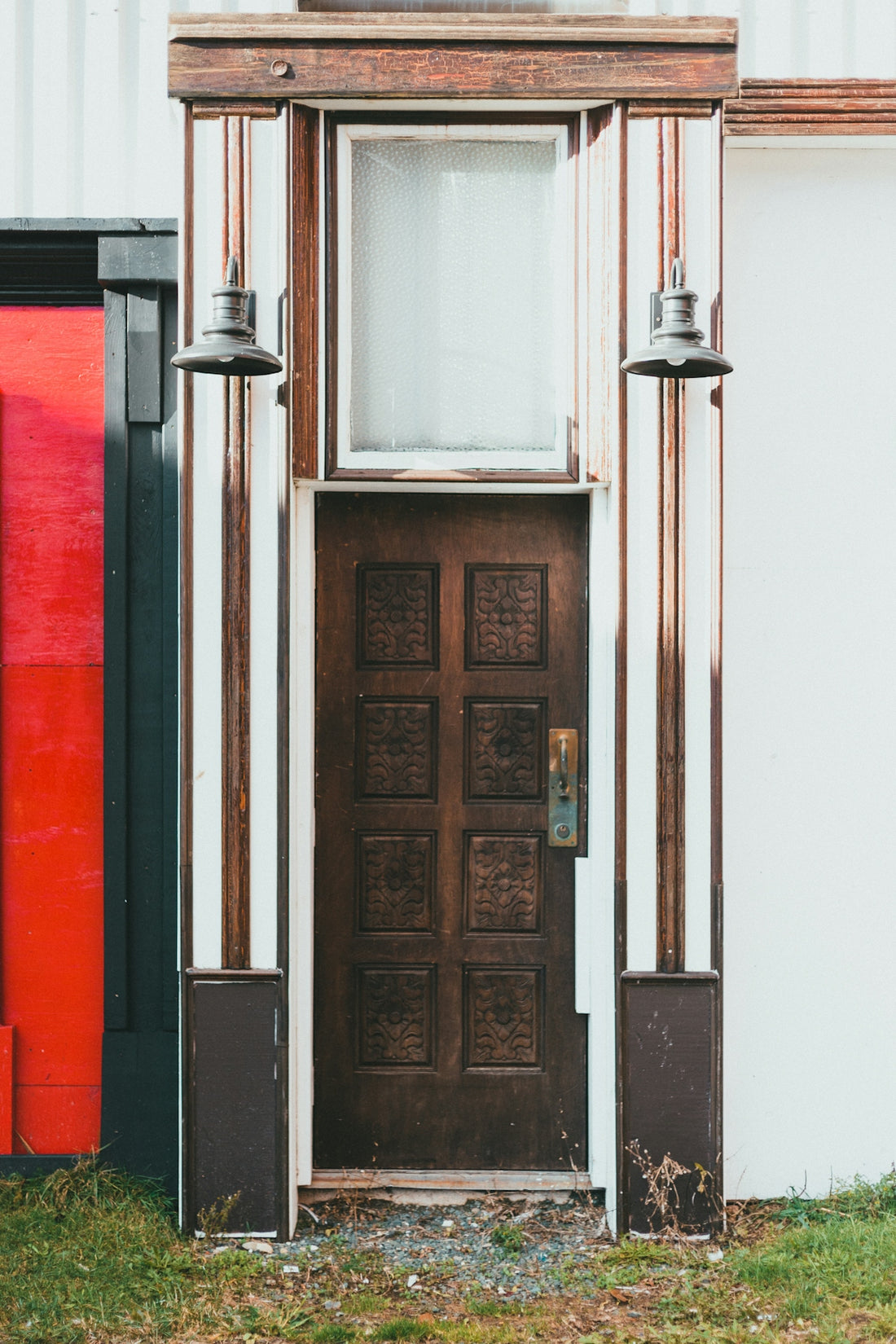 brown wooden door with black steel door lever