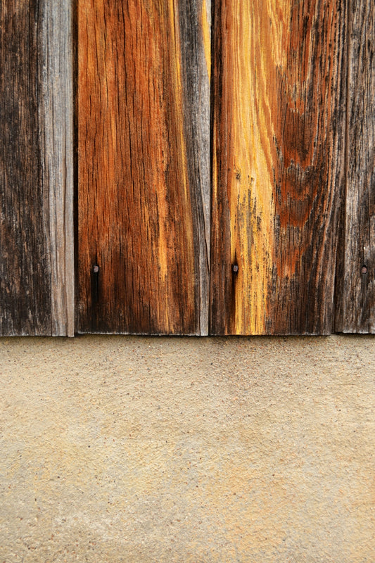 brown wooden board on white concrete wall