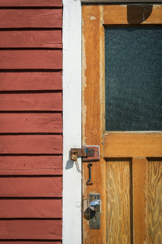 a wooden door with a phone on the side of it