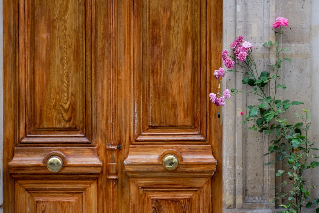 a close up of a wooden door with pink flowers
