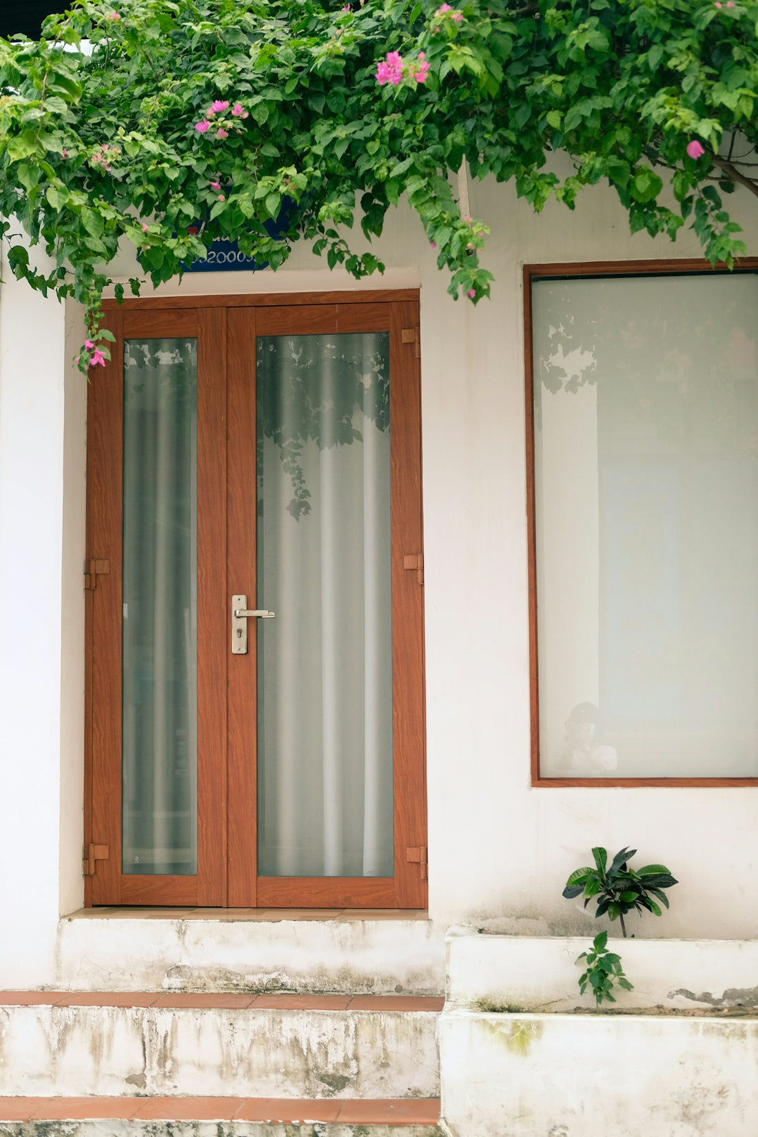 a wooden door sitting next to a window