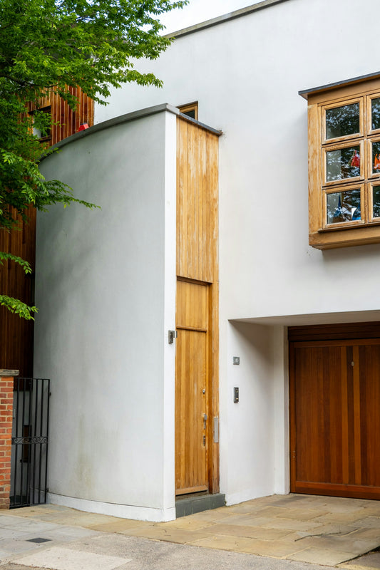 a white building with a wooden door and window