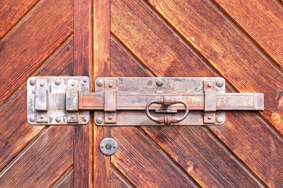 a close up of a metal latch on a wooden door