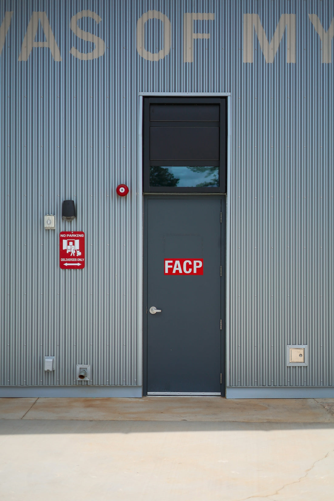 a gray door with a faccp sticker on it