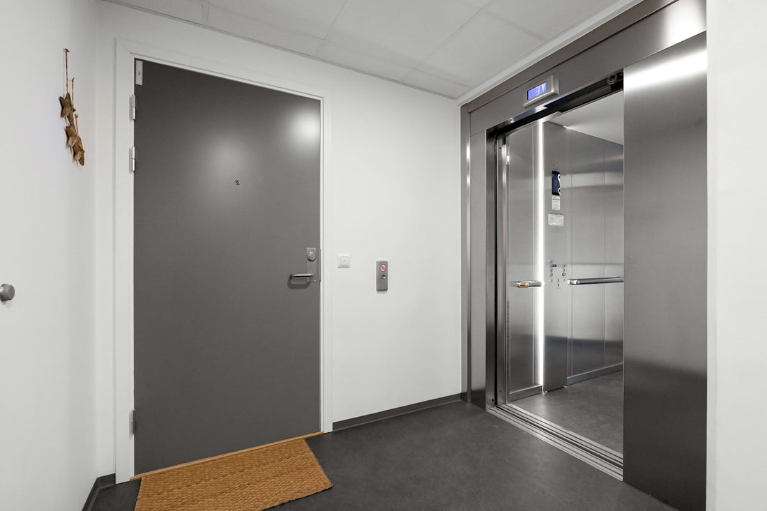 A hallway with a door and a towel on the floor