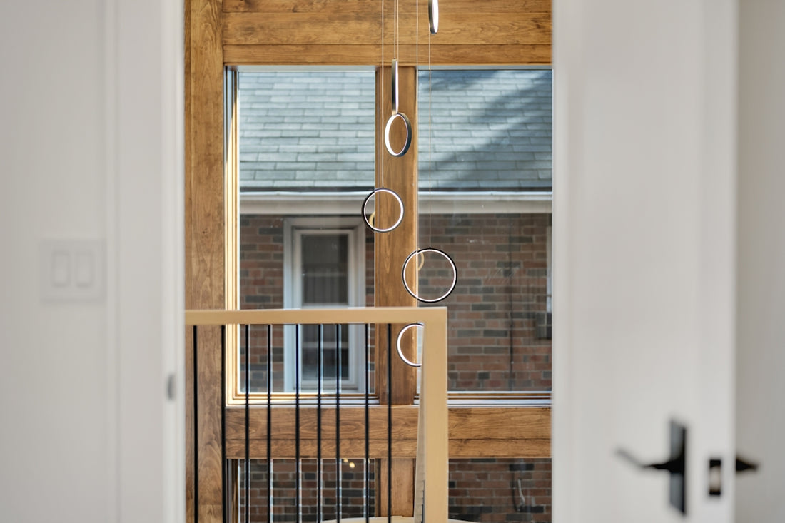 Gymnastic rings hanging from wooden beams indoors