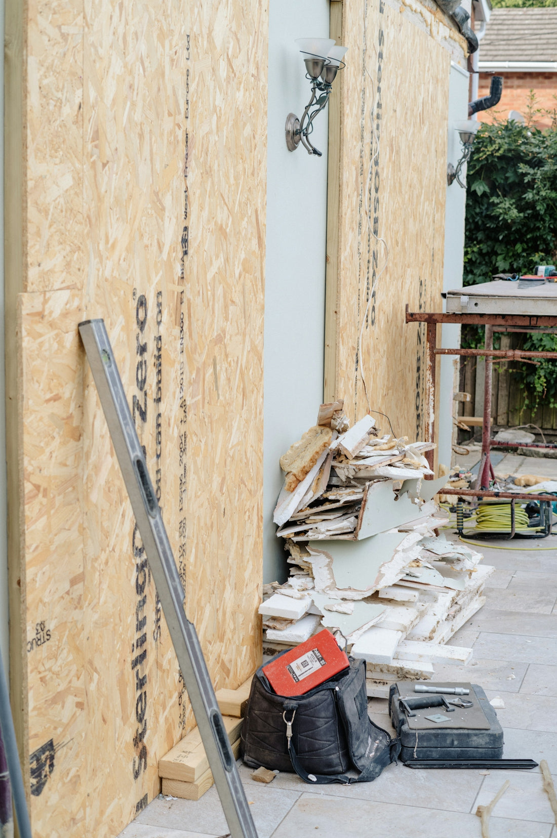 Building renovation with plywood wall and construction debris